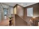 Hallway featuring wood flooring, textured walls, and doors leading to multiple rooms in the home at 4215 Macadamia Dr, Las Vegas, NV 89115