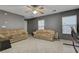 Spacious living room features tile flooring, ceiling fans, and tan sofas at 4215 Macadamia Dr, Las Vegas, NV 89115