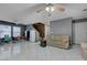 Spacious living room features tile flooring, tan couch, and a staircase at 4215 Macadamia Dr, Las Vegas, NV 89115