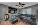 Comfortable living room with a black leather sectional and a flat screen tv at 4215 Macadamia Dr, Las Vegas, NV 89115
