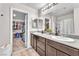 Bright bathroom with dual sinks, granite countertops, and walk-in closet at 4332 Stardusk Falls Ave, North Las Vegas, NV 89084