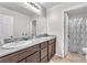 Bathroom featuring double sinks, granite countertops, and tile flooring with a shower/tub combination at 4332 Stardusk Falls Ave, North Las Vegas, NV 89084