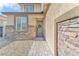 Close-up of the house's inviting front door and charming stone facade with desert landscaping at 4332 Stardusk Falls Ave, North Las Vegas, NV 89084