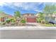 Charming two-story home featuring a well-manicured front yard and brick paved driveway at 4332 Stardusk Falls Ave, North Las Vegas, NV 89084
