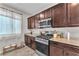 Cozy kitchen with stainless steel appliances, granite countertops, and sleek dark wood cabinets at 4332 Stardusk Falls Ave, North Las Vegas, NV 89084