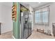 Kitchen area featuring stainless steel refrigerator, ample cabinet space, and neutral tile flooring at 4332 Stardusk Falls Ave, North Las Vegas, NV 89084