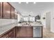 A kitchen that overlooks a living room with stainless steel appliances and granite countertops at 4332 Stardusk Falls Ave, North Las Vegas, NV 89084