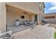Relaxing outdoor covered patio with a ceiling fan, table and chairs, mini fridge and BBQ at 4332 Stardusk Falls Ave, North Las Vegas, NV 89084