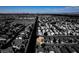 Dramatic overhead shot of a neighborhood with a central road and homes with manicured lawns at 4512 Long Horse Ct, Las Vegas, NV 89147