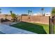 Enclosed backyard featuring a patio with outdoor seating, a grassy area, and a brick perimeter wall at 4512 Long Horse Ct, Las Vegas, NV 89147