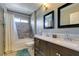Gray-toned bathroom with double sinks, tub, and tile shower at 4512 Long Horse Ct, Las Vegas, NV 89147