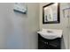 Powder room featuring dark wood vanity and framed mirror above sink at 4512 Long Horse Ct, Las Vegas, NV 89147