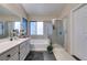 This bathroom offers double sinks, and a separate shower and tub with modern gray tiling at 4512 Long Horse Ct, Las Vegas, NV 89147