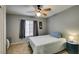 This cozy bedroom includes a ceiling fan, window with blinds, and a full sized bed at 4512 Long Horse Ct, Las Vegas, NV 89147