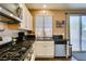 Modern kitchen featuring stainless steel appliances and a view of the outdoor area through a sliding door at 4512 Long Horse Ct, Las Vegas, NV 89147