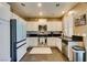 Bright kitchen with white cabinets, stainless steel appliances, and a contrasting black countertop at 4512 Long Horse Ct, Las Vegas, NV 89147