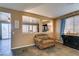Open-concept living room with neutral paint, tiled floors, and access to a dining area at 4512 Long Horse Ct, Las Vegas, NV 89147