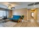 Inviting living room with a bright interior, wood flooring, and a ceiling fan at 4512 Long Horse Ct, Las Vegas, NV 89147