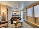Living room with tile flooring and view to kitchen and backyard at 4512 Long Horse Ct, Las Vegas, NV 89147