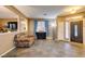 Open-concept living room with neutral paint, tiled floors, and an adjacent dining area at 4512 Long Horse Ct, Las Vegas, NV 89147