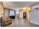 Open-concept living room with neutral paint, tiled floors, and a bright front entrance at 4512 Long Horse Ct, Las Vegas, NV 89147