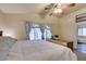 Bright main bedroom features a large window with gray curtains and a comfortable king bed at 4512 Long Horse Ct, Las Vegas, NV 89147