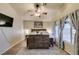 Inviting main bedroom with ceiling fan, decorative rug, and large window for natural light at 4512 Long Horse Ct, Las Vegas, NV 89147