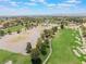 Scenic aerial view showcasing the lush community golf course with mature trees and serene landscaping at 5225 Sandy Cactus Ln, Las Vegas, NV 89149