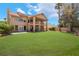 Expansive backyard showcasing a two-story home with a large upstairs balcony at 5225 Sandy Cactus Ln, Las Vegas, NV 89149