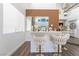 Modern bar area with white countertop, wood accent wall, and stylish bar stools at 5225 Sandy Cactus Ln, Las Vegas, NV 89149