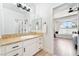 Bathroom with an extended countertop and sink, leading to a well lit bedroom at 5225 Sandy Cactus Ln, Las Vegas, NV 89149