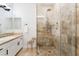 Bright bathroom features neutral tile, a glass shower with patterned tile, plus a sink and vanity at 5225 Sandy Cactus Ln, Las Vegas, NV 89149