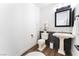 Well-lit powder room featuring white fixtures, patterned tile accent, and neutral decor, creating a clean, inviting space at 5225 Sandy Cactus Ln, Las Vegas, NV 89149