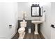 Elegant powder room showcasing classic fixtures, stylish vanity, and a decorative flower arrangement adding a touch of sophistication at 5225 Sandy Cactus Ln, Las Vegas, NV 89149