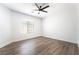 A clean, sunlit bedroom with wood-look flooring and a ceiling fan at 5225 Sandy Cactus Ln, Las Vegas, NV 89149