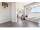 Bedroom featuring an arched window, mirrored closet doors, and hardwood floors at 5225 Sandy Cactus Ln, Las Vegas, NV 89149