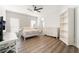 Bright bedroom with hard floors, a large bed, modern white furniture, and a ceiling fan for comfort at 5225 Sandy Cactus Ln, Las Vegas, NV 89149