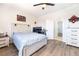 Cozy bedroom with wood-look flooring, ceiling fan, and a playful decor at 5225 Sandy Cactus Ln, Las Vegas, NV 89149