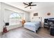 Bright bedroom featuring a large arched window, ceiling fan, and a neutral color palette at 5225 Sandy Cactus Ln, Las Vegas, NV 89149