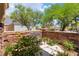 Cozy courtyard with a stone bench, lush greenery, and a charming ambiance at 5225 Sandy Cactus Ln, Las Vegas, NV 89149