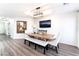 Bright dining room with a rustic wooden table, bench, and chairs, with a modern light fixture at 5225 Sandy Cactus Ln, Las Vegas, NV 89149