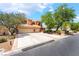 Beautiful two-story home boasting lush landscaping, a spacious driveway, and a convenient three-car garage at 5225 Sandy Cactus Ln, Las Vegas, NV 89149