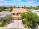 Elevated view of a two-story home featuring a tile roof and a three-car garage at 5225 Sandy Cactus Ln, Las Vegas, NV 89149