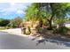 Attractive two-story home showcasing mature landscaping, a three-car garage, and a well-maintained lawn at 5225 Sandy Cactus Ln, Las Vegas, NV 89149