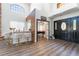 Stylish foyer featuring a bar, wood floors, and an open entryway to a billiard room, perfect for entertaining at 5225 Sandy Cactus Ln, Las Vegas, NV 89149