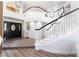Elegant foyer featuring a curved staircase, high ceilings, and stylish lighting, creating a grand entrance at 5225 Sandy Cactus Ln, Las Vegas, NV 89149