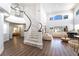 Spacious foyer showcasing a curved staircase, high ceilings, and an open layout leading to the living area at 5225 Sandy Cactus Ln, Las Vegas, NV 89149