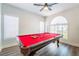 Game room with a striking red pool table positioned in front of an arched window at 5225 Sandy Cactus Ln, Las Vegas, NV 89149
