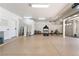 Spacious garage featuring ample storage cabinets and fitness equipment, including a treadmill and bicycle at 5225 Sandy Cactus Ln, Las Vegas, NV 89149