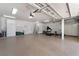 Large, organized garage with epoxy flooring, built-in cabinets, and fitness equipment at 5225 Sandy Cactus Ln, Las Vegas, NV 89149